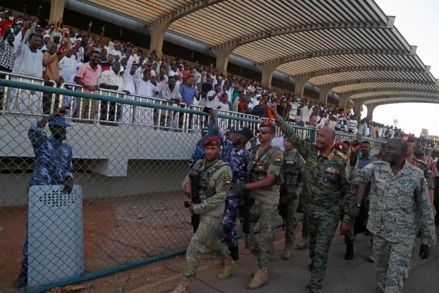 Sudan's de facto leader and army chief Abdel Fattah al-Burhan waves to spectators after attending the Sudanese Premier League's opening football match between Al Merrikh and Ahli Madani at the Kober Stadium in Khartoum North, on May 15, 2026. Football returned to Sudan's war-scarred capital on May 15 as the domestic league staged its first matches since the conflict began at battered stadiums on the edges of a largely abandoned Khartoum. (Photo by Ebrahim Hamid / AFP)