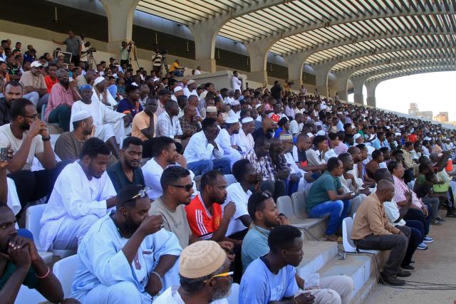 Spectators watch the Sudanese Premier League's opening football match between Al Merrikh and Ahli Madani at the Kober Stadium in Khartoum North, on May 15, 2026. Football returned to Sudan's war-scarred capital on May 15 as the domestic league staged its first matches since the conflict began at battered stadiums on the edges of a largely abandoned Khartoum. (Photo by Ebrahim Hamid / AFP)