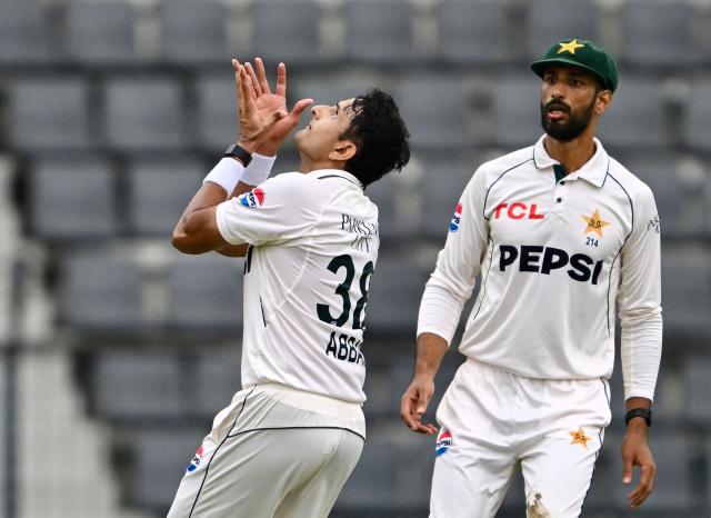 Pakistan’s captain Shan Masood (R) watches as Mohammad Abbas attempts to take a catch of Bangladesh’s Tanzid Hasan during the first day of the second Test cricket match between Bangladesh and Pakistan at the Sylhet International Cricket Stadium in Sylhet on May 16, 2026. (Photo by MUNIR UZ ZAMAN / AFP)