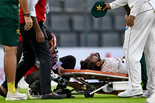 Pakistan's Hasan Ali is assisted off the field on a stretcher after suffering an injury during the first day of the second Test cricket match between Bangladesh and Pakistan at the Sylhet International Cricket Stadium in Sylhet on May 16, 2026. (Photo by MUNIR UZ ZAMAN / AFP)