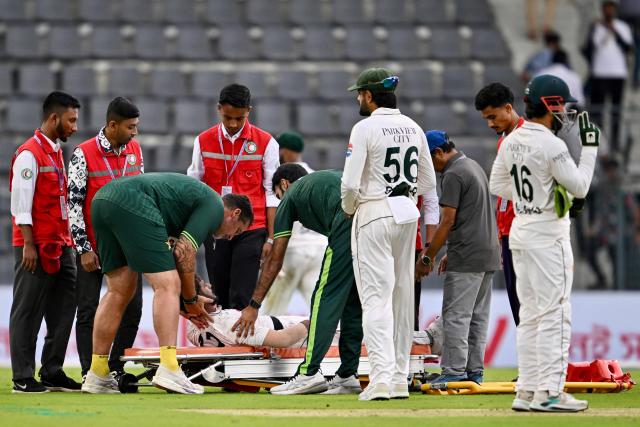 Pakistan's Hasan Ali is assisted off the field on a stretcher after suffering an injury during the first day of the second Test cricket match between Bangladesh and Pakistan at the Sylhet International Cricket Stadium in Sylhet on May 16, 2026. (Photo by Munir UZ ZAMAN / AFP)