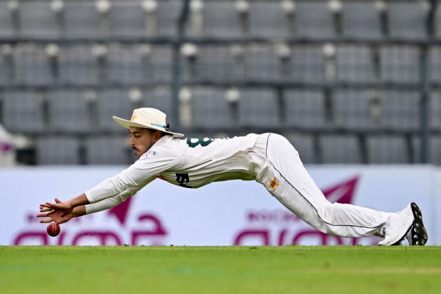 Pakistan’s Azan Awais dives to field the ball during the first day of the second Test cricket match between Bangladesh and Pakistan at the Sylhet International Cricket Stadium in Sylhet on May 16, 2026. (Photo by Munir UZ ZAMAN / AFP)