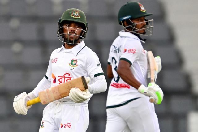 Bangladesh’s Mominul Haque (L) and captain Najmul Hossain Shanto run between the wickets during the first day of the second Test cricket match between Bangladesh and Pakistan at the Sylhet International Cricket Stadium in Sylhet on May 16, 2026. (Photo by Munir UZ ZAMAN / AFP)