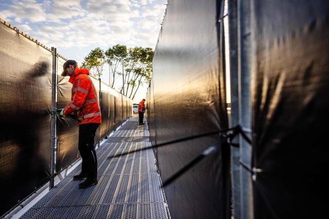 Employees prepare for the arrival of the Dutch Hantavirus-hit cruise ship MV Hondius at the port of Rotterdam on May 16, 2026. Cruise ship MV Hondius is expected to arrive at the port of Rotterdam on May 18, 2026. (Photo by Jeffrey Groeneweg / ANP / AFP) / Netherlands OUT