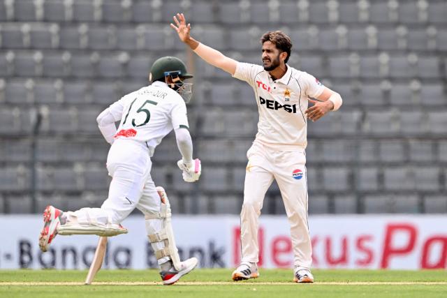 Pakistan’s Hasan Ali (R) gestures as Bangladesh’s Mushfiqur Rahim runs between the wickets during the first day of the second Test cricket match between Bangladesh and Pakistan at the Sylhet International Cricket Stadium in Sylhet on May 16, 2026. (Photo by Munir UZ ZAMAN / AFP)