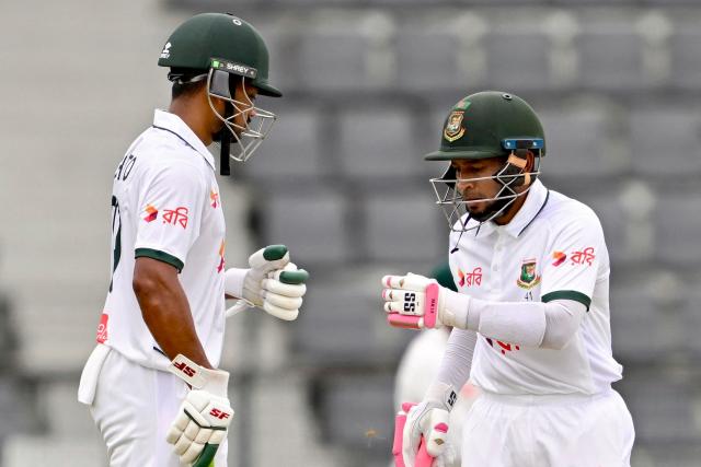 Bangladesh’s Mushfiqur Rahim (R) bumps his fists with captain Najmul Hossain Shanto during the first day of the second Test cricket match between Bangladesh and Pakistan at the Sylhet International Cricket Stadium in Sylhet on May 16, 2026. (Photo by Munir UZ ZAMAN / AFP)