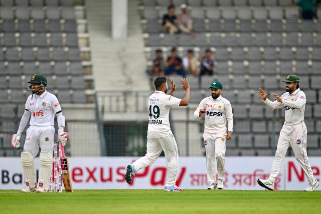Pakistan’s Khurram Shahzad (2L) celebrates with teammates after taking the wicket of Bangladesh’s Mushfiqur Rahim (L) during the first day of the second Test cricket match between Bangladesh and Pakistan at the Sylhet International Cricket Stadium in Sylhet on May 16, 2026. (Photo by Munir UZ ZAMAN / AFP)