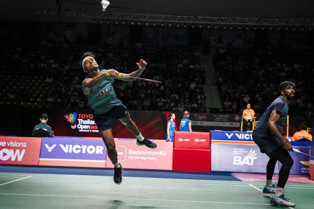 India’s Chirag Shetty (L) and Satwiksairaj Rankireddy play a point against Malaysia's Goh Sze Fei and Nur Izzudin during their men's doubles semi-final match at the Thailand Open badminton tournament in Bangkok on May 16, 2026. (Photo by chanakarn LAOSARAKHAM / AFP)