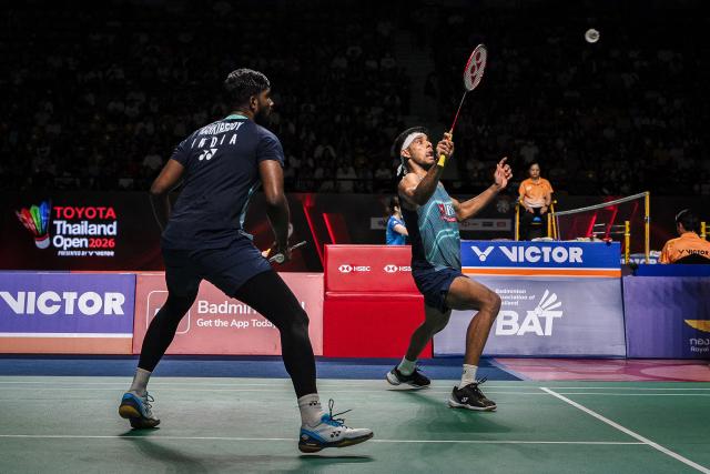 India’s Chirag Shetty (R) and Satwiksairaj Rankireddy play a point against Malaysia's Goh Sze Fei and Nur Izzudin during their men's doubles semi-final match at the Thailand Open badminton tournament in Bangkok on May 16, 2026. (Photo by chanakarn LAOSARAKHAM / AFP)