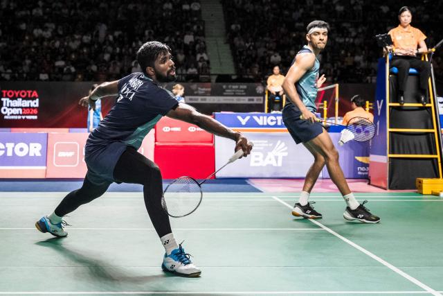 India’s Chirag Shetty (R) and Satwiksairaj Rankireddy play a point against Malaysia's Goh Sze Fei and Nur Izzudin during their men's doubles semi-final match at the Thailand Open badminton tournament in Bangkok on May 16, 2026. (Photo by chanakarn LAOSARAKHAM / AFP)