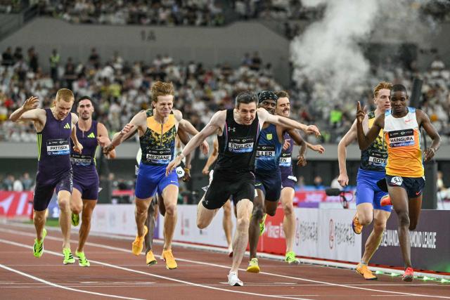 Ireland's Mark English (C) crosses the finish line to win the men's 800m event and break the meeting's record during the Shanghai/Keqiao Diamond League athletics meeting in Keqiao, Shaoxing in China's eastern Zhejiang province on May 16, 2026. (Photo by HECTOR RETAMAL / AFP)