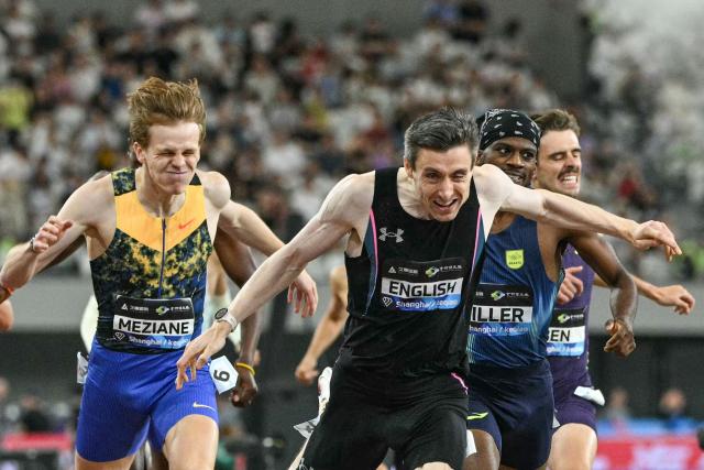 Ireland's Mark English (C) crosses the finish line to win the men's 800m event and break the meeting's record during the Shanghai/Keqiao Diamond League athletics meeting in Keqiao, Shaoxing in China's eastern Zhejiang province on May 16, 2026. (Photo by HECTOR RETAMAL / AFP)