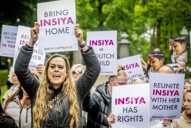 Demonstrators holding placards reading “Bring Insiya home” (L) and “Reunite Insiya with her mother” (R), referring to Insiya, who was abducted in 2016 in Amsterdam at the age of two and taken to India where she remains with her father, shout slogans during a protest outside Huis ten Bosch Palace in The Hague on May 16, 2026, on the occasion of Indian President Narendra Modi’s visit to King Willem-Alexander. Narendra Modi visits Netherlands for a three days trip from May 15 until May 17. (Photo by Robin Utrecht / ANP / AFP) / Netherlands OUT