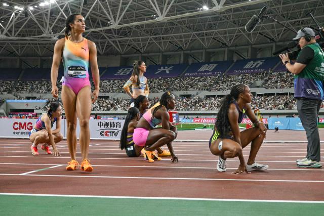 Jamaica's Shericka Jackson (C) reacts after winning the women's 200m event during the Shanghai/Keqiao Diamond League athletics meeting in Keqiao, Shaoxing in China's eastern Zhejiang province on May 16, 2026. (Photo by Hector RETAMAL / AFP)