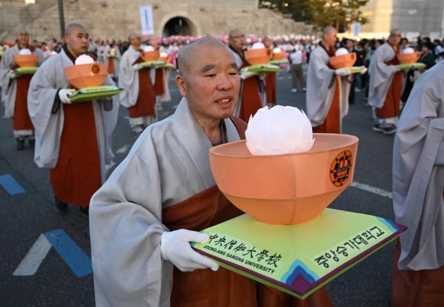 Buddhist monks march with lanterns during a parade as part of a 'Lotus Lantern Festival' to celebrate the upcoming Buddha's birthday, in Seoul on May 16, 2026. (Photo by Jung Yeon-je / AFP)