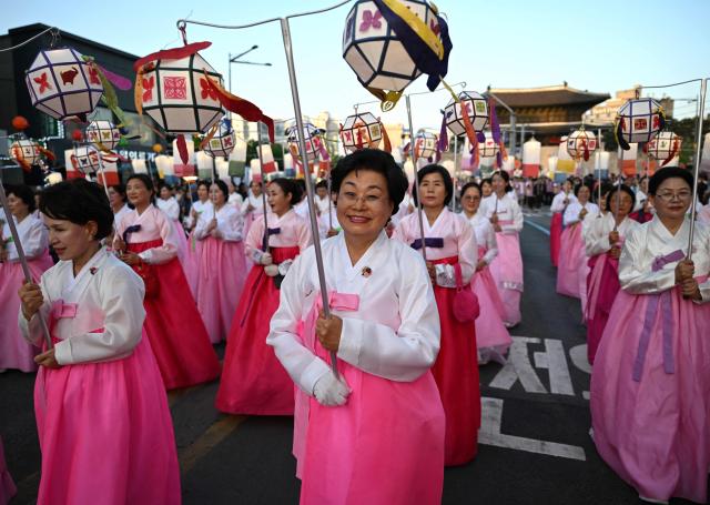 Participants march with lanterns during a parade as part of a 'Lotus Lantern Festival' to celebrate the upcoming Buddha's birthday, in Seoul on May 16, 2026. (Photo by Jung Yeon-je / AFP)