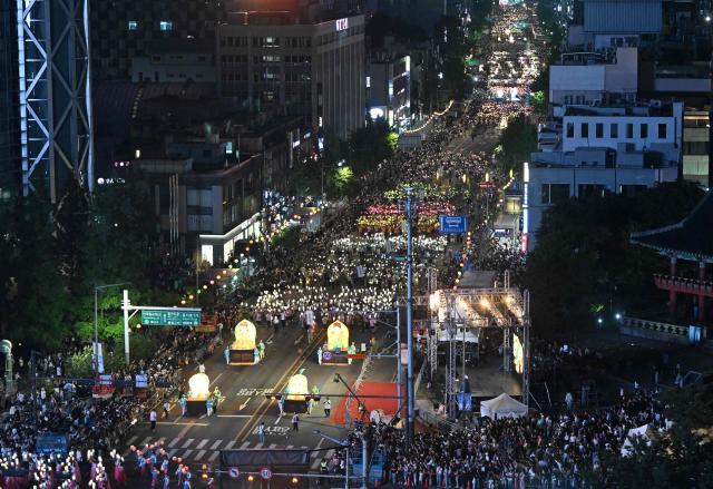 Participants march with lanterns during a parade as part of a 'Lotus Lantern Festival' to celebrate the upcoming Buddha's birthday, in Seoul on May 16, 2026. (Photo by Jung Yeon-je / AFP)