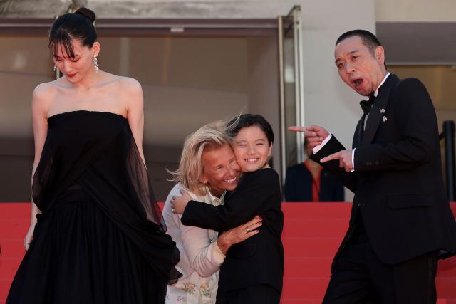 President of the Cannes Film Festival Iris Knobloch (C-L) greets Japanese actor Rimu Kuwaki next to Japanese actress Haruka Ayase (L) and Japanese actor and comedian Daigo Yamamoto as they arrive for the screening of the film "Sheep in The Box" at the 79th edition of the Cannes Film Festival in Cannes, southern France on May 16, 2026. (Photo by Thibaud MORITZ / AFP)