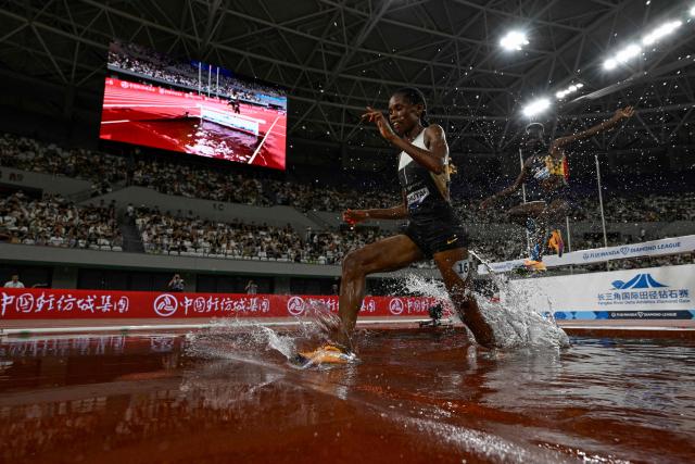 Uganda's Peruth Chemutai (L) competes in the women's 3000m steeplechase event during the Shanghai/Keqiao Diamond League athletics meeting in Keqiao, Shaoxing in China's eastern Zhejiang province on May 16, 2026. (Photo by WANG Zhao / AFP)