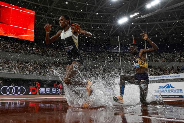 Uganda's Peruth Chemutai (L) competes in the women's 3000m steeplechase event during the Shanghai/Keqiao Diamond League athletics meeting in Keqiao, Shaoxing in China's eastern Zhejiang province on May 16, 2026. (Photo by WANG Zhao / AFP)