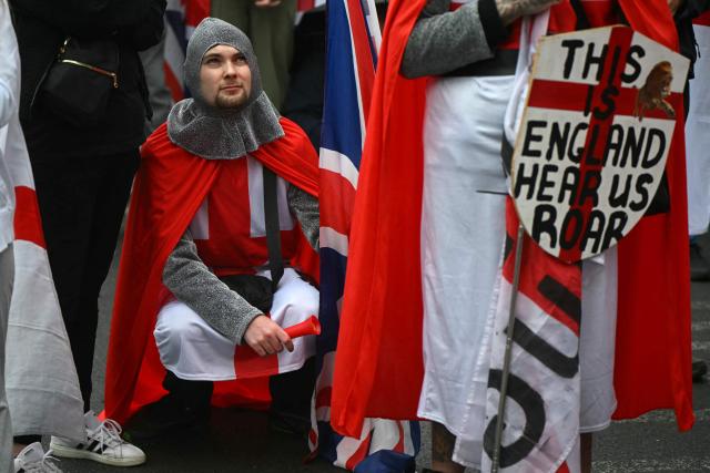A supporter of British far-right activist Tommy Robinson, real name Stephen Yaxley-Lennon, in costume, takes part in a march organised by Unite The Kingdom, in central London on May 16, 2026. (Photo by JUSTIN TALLIS / AFP)