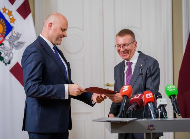 Latvia's President Edgars Rinkevics (R) announces that he asked Andris Kulbergs (L) to form a new cabinet of ministers after he met with all factions of the Saeima, Latvia's parliament, on May 16, 2026 in Riga, Latvia. Latvia's Prime Minister Evika Silina had resigned on May 14, 2026 over her government's handling of Ukrainian drones that strayed into Latvian territory during attacks in Russia. (Photo by Gints Ivuskans and AFP / AFP)