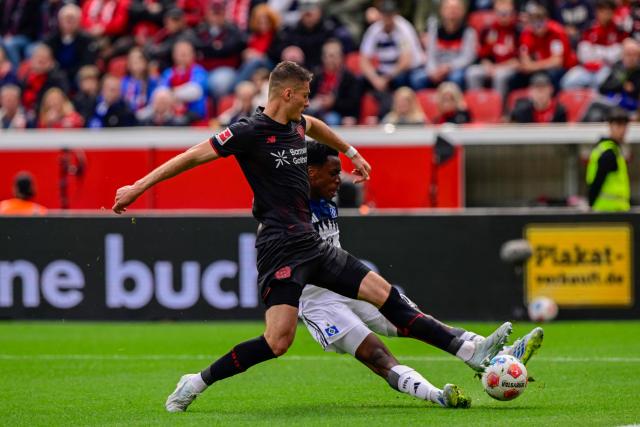 Bayer Leverkusen's Czech forward #14 Patrik Schick and Hamburg's Belgian-Congolese midfielder #06 Albert Sambi Lokonga vie for the ball during the German first division Bundesliga football match between Bayer Leverkusen and Hamburger SV (HSV) in Leverkusen, western Germany, on May 16, 2026. (Photo by INA FASSBENDER / AFP) / DFL REGULATIONS PROHIBIT ANY USE OF PHOTOGRAPHS AS IMAGE SEQUENCES AND/OR QUASI-VIDEO