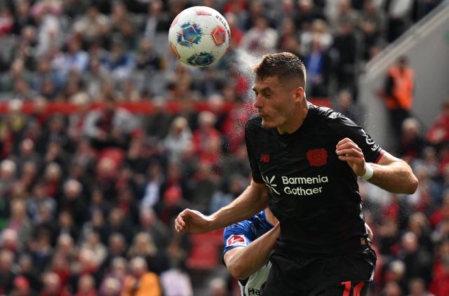 Bayer Leverkusen's Czech forward #14 Patrik Schick and Hamburg's Croatian defender #44 Luka Vuskovic vie for the ball during the German first division Bundesliga football match between Bayer Leverkusen and Hamburger SV (HSV) in Leverkusen, western Germany, on May 16, 2026. (Photo by INA FASSBENDER / AFP) / DFL REGULATIONS PROHIBIT ANY USE OF PHOTOGRAPHS AS IMAGE SEQUENCES AND/OR QUASI-VIDEO