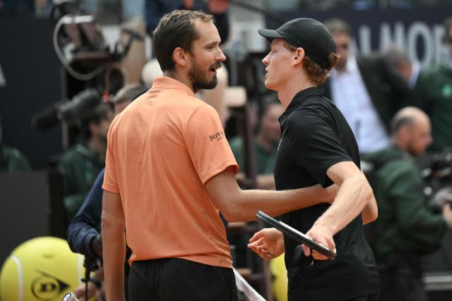 Italy's Jannik Sinner is congratulated by Russia's Daniil Medvedev (L) after winning the semi-final at the ATP Rome Open tennis tournament at Foro Italico in Rome on May 16, 2026. (Photo by Tiziana FABI / AFP)
