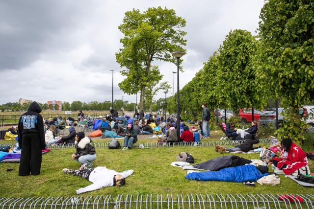 Fans of British singer Harry Styles await outside the Johan Cruijff ArenA, the day before he begins his ten-day concert series and his world tour Together, Together Tour in Amsterdam on May 15, 2026. Ten years after One Direction split up, British singer Harry Styles, who is setting off on tour this May 16, 2026, in Amsterdam with his fourth album, has established himself as one of the world’s biggest pop stars, thanks to his stage presence and his embodiment of a new form of masculinity. (Photo by Dingena Mol / ANP / AFP) / Netherlands OUT