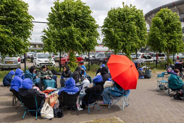 Fans of British singer Harry Styles await outside the Johan Cruijff ArenA, the day before he begins his ten-day concert series and his world tour Together, Together Tour in Amsterdam on May 15, 2026. Ten years after One Direction split up, British singer Harry Styles, who is setting off on tour this May 16, 2026, in Amsterdam with his fourth album, has established himself as one of the world’s biggest pop stars, thanks to his stage presence and his embodiment of a new form of masculinity. (Photo by Dingena Mol / ANP / AFP) / Netherlands OUT
