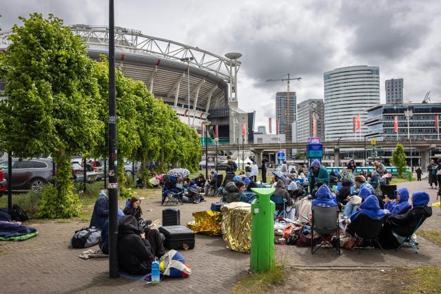 Fans of British singer Harry Styles await outside the Johan Cruijff ArenA, the day before he begins his ten-day concert series and his world tour Together, Together Tour in Amsterdam on May 15, 2026. Ten years after One Direction split up, British singer Harry Styles, who is setting off on tour this May 16, 2026, in Amsterdam with his fourth album, has established himself as one of the world’s biggest pop stars, thanks to his stage presence and his embodiment of a new form of masculinity. (Photo by Dingena Mol / ANP / AFP) / Netherlands OUT