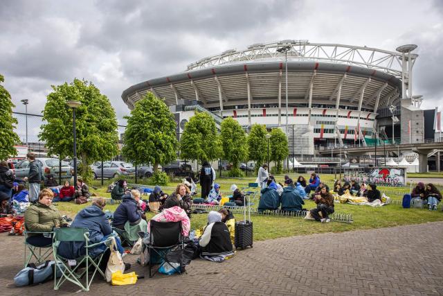 Fans of British singer Harry Styles await outside the Johan Cruijff ArenA, the day before he begins his ten-day concert series and his world tour Together, Together Tour in Amsterdam on May 15, 2026. Ten years after One Direction split up, British singer Harry Styles, who is setting off on tour this May 16, 2026, in Amsterdam with his fourth album, has established himself as one of the world’s biggest pop stars, thanks to his stage presence and his embodiment of a new form of masculinity. (Photo by Dingena Mol / ANP / AFP) / Netherlands OUT