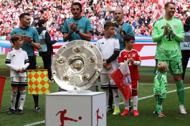 Bayern Munich's German goalkeeper #01 Manuel Neuer (R) and German referee Deniz Aytekin (2nd L) clap their hands prior to the start of prior to the start of the German first division Bundesliga football match between FC Bayern Munich and FC Cologne in Munich, southern Germany, on May 16, 2026. (Photo by Alexandra BEIER / AFP) / DFL REGULATIONS PROHIBIT ANY USE OF PHOTOGRAPHS AS IMAGE SEQUENCES AND/OR QUASI-VIDEO