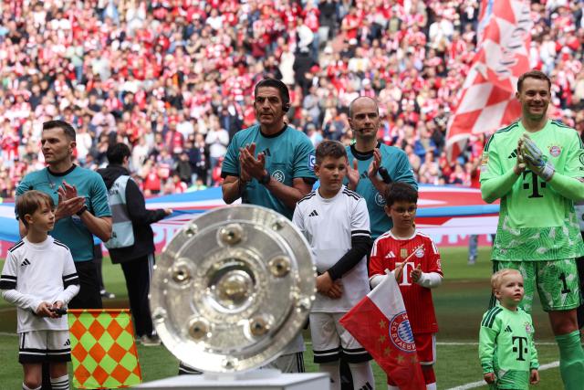 Bayern Munich's German goalkeeper #01 Manuel Neuer (R) and German referee Deniz Aytekin (2nd L) clap their hands prior to the start of prior to the start of the German first division Bundesliga football match between FC Bayern Munich and FC Cologne in Munich, southern Germany, on May 16, 2026. (Photo by Alexandra BEIER / AFP) / DFL REGULATIONS PROHIBIT ANY USE OF PHOTOGRAPHS AS IMAGE SEQUENCES AND/OR QUASI-VIDEO