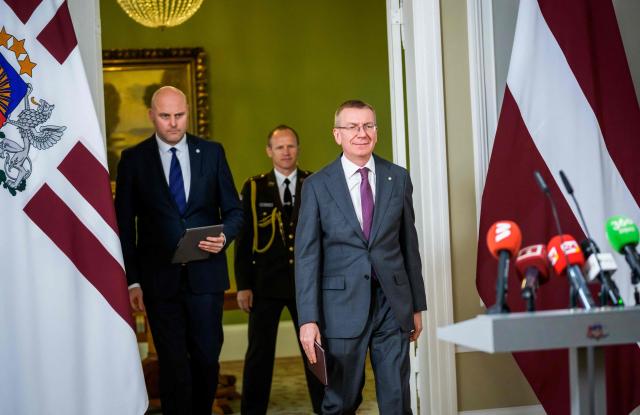 Latvia's President Edgars Rinkevics (R) arrives with Andris Kulbergs (L)  for a press conference to announce that he asked Kulbergs to form a new cabinet of ministers after he met with all factions of the Saeima, Latvia's parliament, on May 16, 2026 in Riga, Latvia. Latvia's Prime Minister Evika Silina had resigned on May 14, 2026 over her government's handling of Ukrainian drones that strayed into Latvian territory during attacks in Russia. (Photo by Gints Ivuskans and AFP / AFP)