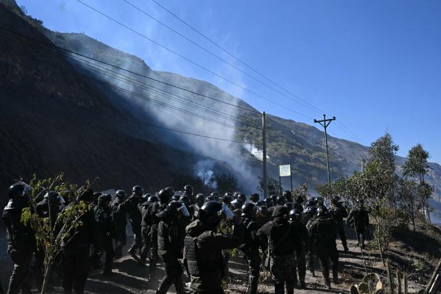 Riot police officers clash with rural protesters amid tear gas in Lipari, La Paz department, Bolivia, on May 16, 2026. Bolivia's government reached an agreement on May 15 with thousands of miners who clashed with police in a protest that paralysed downtown La Paz. However, other sectors continue to block access routes to the city, home to the executive branch and Congress. (Photo by AIZAR RALDES / AFP)