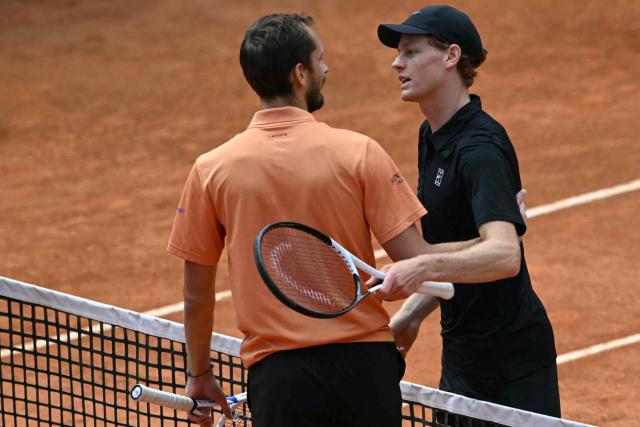 Italy's Jannik Sinner is congratulated by Russia's Daniil Medvedev (L) after winning the semi-final at the ATP Rome Open tennis tournament at Foro Italico in Rome on May 16, 2026. (Photo by Andreas SOLARO / AFP)