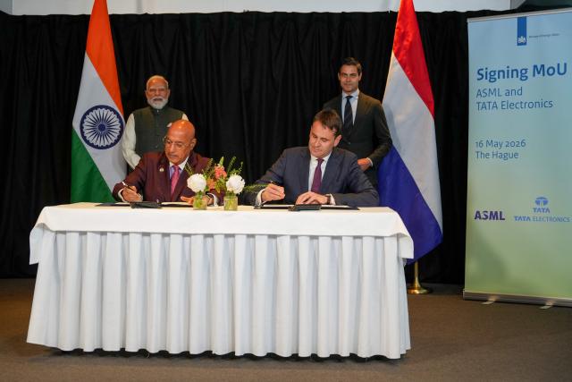 Tata Electronics CEO Randhir Thakur (bottom L) and ASML CEO Christophe Fouquet (bottom R) sign documents for the Memorandums of Understanding (MoU) as Indian Prime Minister Narendra Modi (topL) and Netherlands' Prime Minister Rob Jetten stand during an official visit of India's Prime Minister in The Hague on May 16, 2026. (Photo by Lina Selg / AFP)