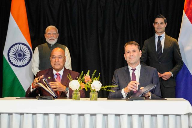 Tata Electronics CEO Randhir Thakur (bottom L) and ASML CEO Christophe Fouquet (bottom R) sign documents as Indian Prime Minister Narendra Modi (topL) and Netherlands' Prime Minister Rob Jetten stand during an official visit of India's Prime Minister in The Hague on May 16, 2026. (Photo by Lina Selg / AFP)