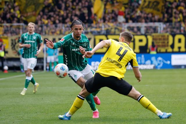 Bremen's German forward #11 Justin Njinmah and Dortmund's German defender #04 Nico Schlotterbeck vie for the ball during the German first division Bundesliga football match between Werder Bremen and Borussia Dortmund in Bremen, northwestern Germany, on May 16, 2026. (Photo by Focke Strangmann / AFP) / DFL REGULATIONS PROHIBIT ANY USE OF PHOTOGRAPHS AS IMAGE SEQUENCES AND/OR QUASI-VIDEO