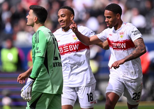 Stuttgart's Danish midfielder #28 Nikolas Nartey (R) celebrates with Stuttgart's German forward #18 Jamie Leweling (C) after scoring the 0-2 goal against Frankfurt's German goalkeeper #23 Michael Zetterer (L) during the German first division Bundesliga football match between Eintracht Frankfurt and VfB Stuttgart in Frankfurt am Main, western Germany, on May 16, 2026. (Photo by Kirill KUDRYAVTSEV / AFP) / DFL REGULATIONS PROHIBIT ANY USE OF PHOTOGRAPHS AS IMAGE SEQUENCES AND/OR QUASI-VIDEO