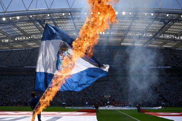 A person waves a FC Porto flag at the start of the Portuguese League football match between FC Porto and CD Santa Clara at the Dragao stadium in Porto on May 16, 2026. (Photo by Miguel RIOPA / AFP)