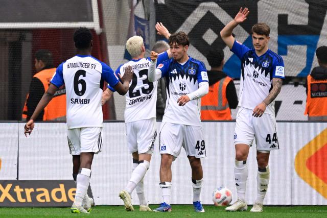 Hamburg's Belgian-Congolese midfielder #06 Albert Sambi Lokonga, Hamburg's Danish midfielder #23 Albert Gronbaek, Hamburg's German forward #49 Otto Stange and Hamburg's Croatian defender #44 Luka Vuskovic celebrate after scoring the opening goal during the German first division Bundesliga football match between Bayer Leverkusen and Hamburger SV (HSV) in Leverkusen, western Germany, on May 16, 2026. (Photo by INA FASSBENDER / AFP) / DFL REGULATIONS PROHIBIT ANY USE OF PHOTOGRAPHS AS IMAGE SEQUENCES AND/OR QUASI-VIDEO