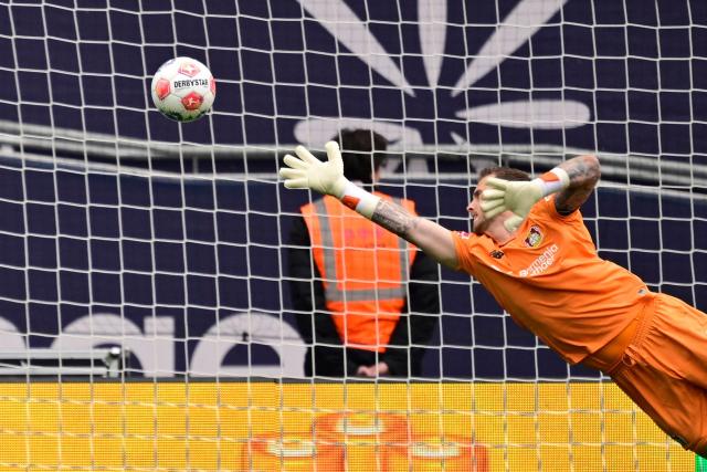 Bayer Leverkusen's Dutch goalkeeper #01 Mark Flekken concedes the opening goal during the German first division Bundesliga football match between Bayer Leverkusen and Hamburger SV (HSV) in Leverkusen, western Germany, on May 16, 2026. (Photo by INA FASSBENDER / AFP) / DFL REGULATIONS PROHIBIT ANY USE OF PHOTOGRAPHS AS IMAGE SEQUENCES AND/OR QUASI-VIDEO