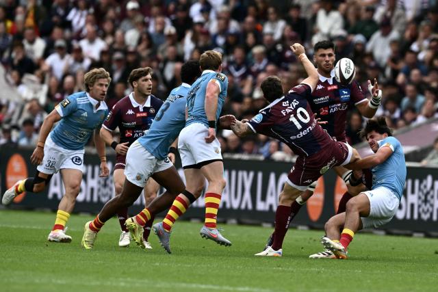 Bordeaux-Begles’ French wing Arthur Retiere is tackled during the French Top 14 rugby union match between Union Bordeaux-Begles (UBB) and USAP Perpignan at the Chaban-Delmas Stadium in Bordeaux, south-western France on May 16, 2026. (Photo by Philippe LOPEZ / AFP)