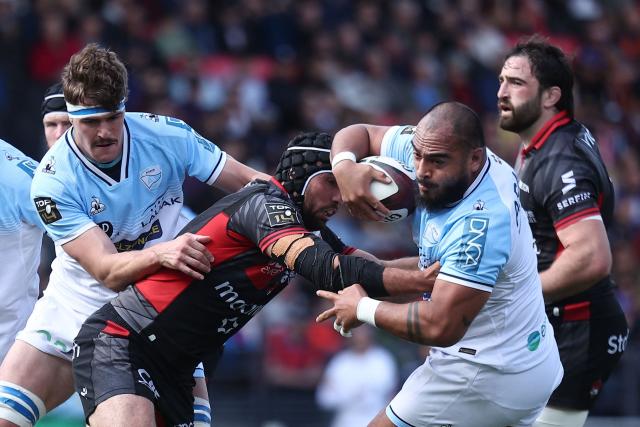 Bayonne’s French prop Emerick Setiano (2nd R) is tackled by Lyon's French centre Theo Millet (C) during the French Top14 rugby union match between Lyon Olympique Universitaire Rugby and Aviron Bayonnais (Bayonne) at the Gerland Stadium in Lyon, central-eastern France on May 16, 2026. (Photo by Alex MARTIN / AFP)