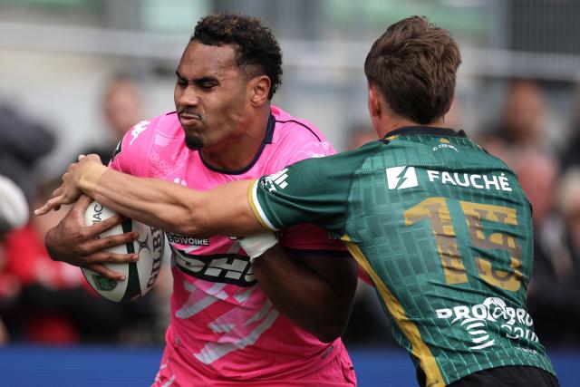 Stade Français' French centre Noah Nene (L) is tackled by Montauban's French full-back Jean Seux (R) during the French Top 14 rugby union match between US Montauban and Stade Français at Stade Sapiac in Montauban, south-western France, on May 16, 2026. (Photo by Valentine CHAPUIS / AFP)