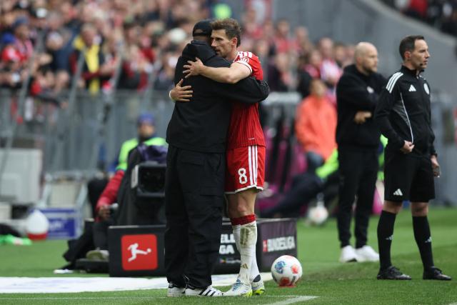 Bayern Munich's German midfielder #08 Leon Goretzka (C) hugs Bayern Munich's Belgian head coach Vincent Kompany (L) as he exits the field during the German first division Bundesliga football match between FC Bayern Munich and FC Cologne in Munich, southern Germany, on May 16, 2026. (Photo by Alexandra BEIER / AFP) / DFL REGULATIONS PROHIBIT ANY USE OF PHOTOGRAPHS AS IMAGE SEQUENCES AND/OR QUASI-VIDEO