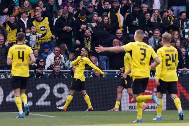Dortmund's Brazilian defender #02 Yan Couto celebrates scoring his team's second goal 0:2 during the German first division Bundesliga football match between Werder Bremen and Borussia Dortmund in Bremen, northwestern Germany, on May 16, 2026. (Photo by Focke Strangmann / AFP) / DFL REGULATIONS PROHIBIT ANY USE OF PHOTOGRAPHS AS IMAGE SEQUENCES AND/OR QUASI-VIDEO